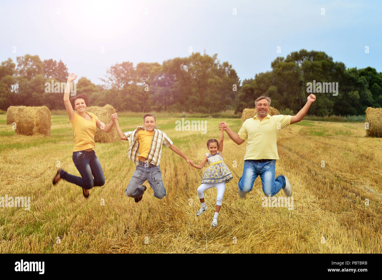 Happy family in wheat field Stock Photo - Alamy