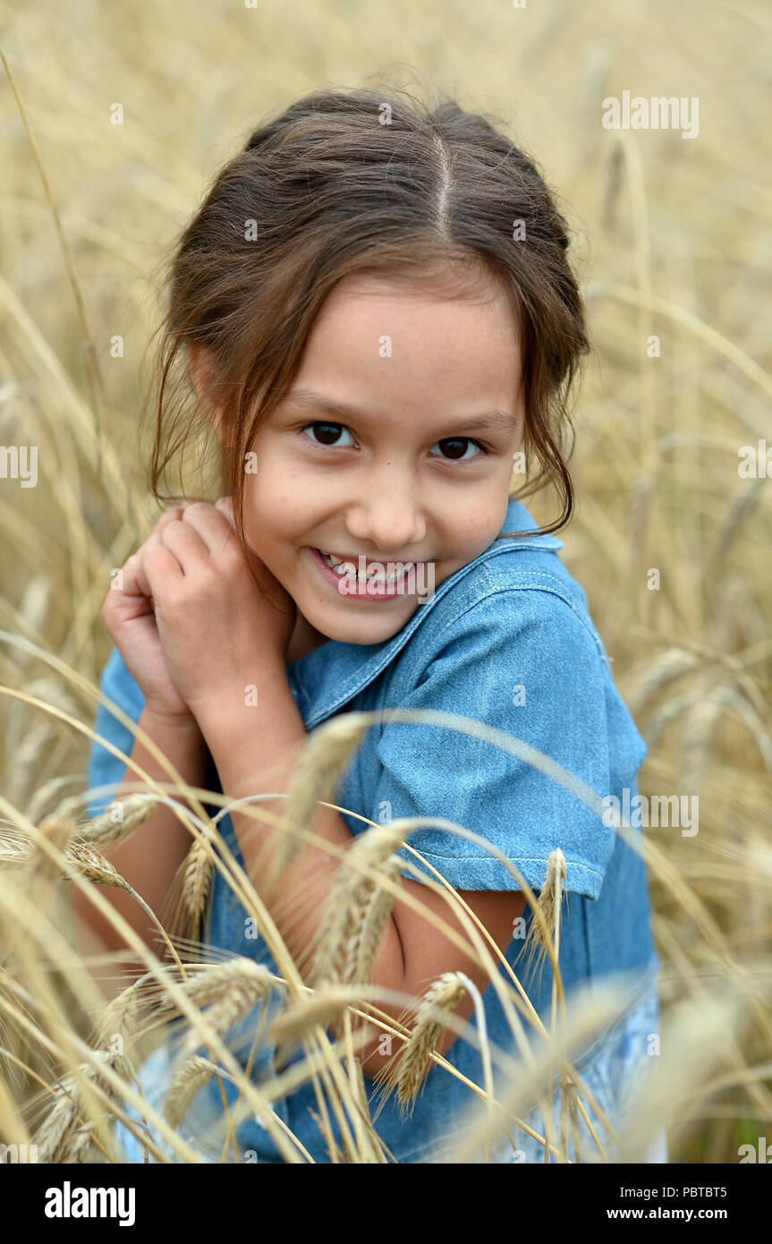 cute Little Girl in wheat field Stock Photo - Alamy