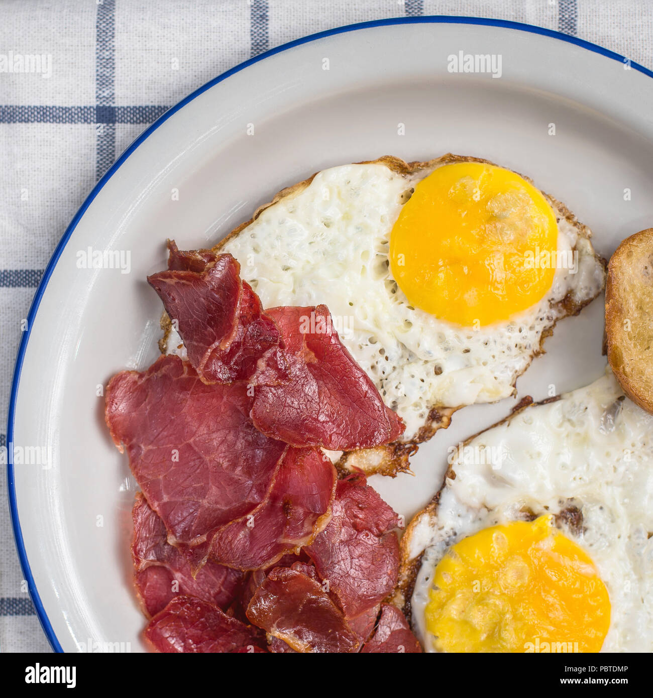 sunny side up fried eggs with pastrami meat Stock Photo Alamy