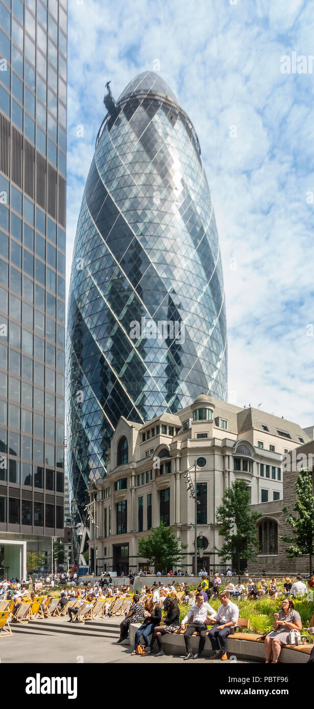 The Gherkin / 30 St Mary Axe, and St Helen's tower above Fitzwilliam House and local workers and