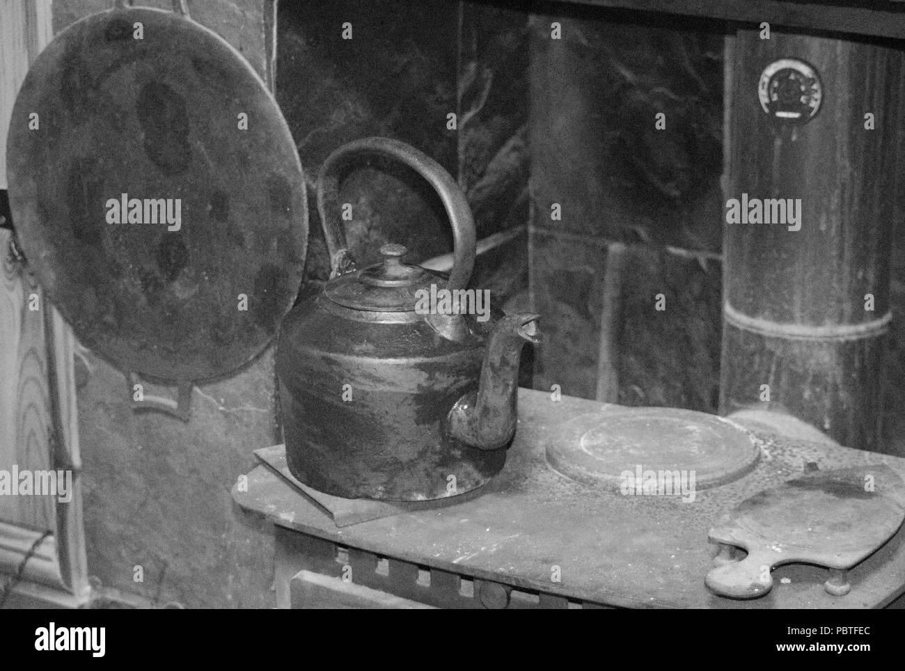 Iron kettle on a wood burning stove Stock Photo Alamy