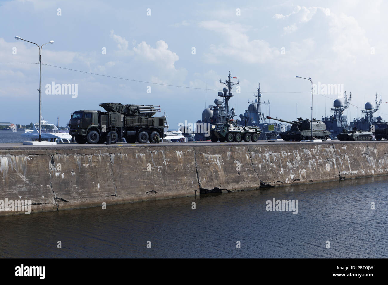 Kronstadt, St. Petersburg, Russia - July 28, 2018: Missile vehicle, armored carrier, artillery, and warships in Kronstadt before the Navy Day parade.  Stock Photo