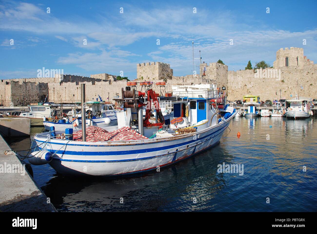 Boats moored in Kolona harbour in Rhodes Old Town on the Greek island of Rhodes on June 12, 2018. The Old Town is a UNESCO World Heritage Ste. Stock Photo