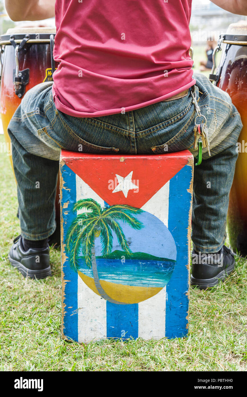 Miami Beach Florida,Flamingo Park,bongo,man men male,player,sitting,painted box,Cuban flag,musician.,FL080930059 Stock Photo
