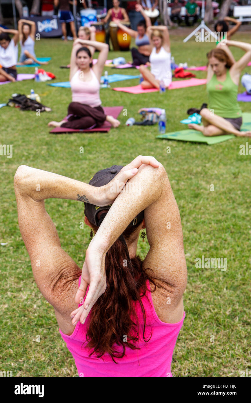 Miami Beach Florida,Flamingo Park,Crunch Yogapalooza,vinyasa yoga,woman female women,exercise,fitness,stretch,mat,posture,wellness,shoulder,elbow,clas Stock Photo