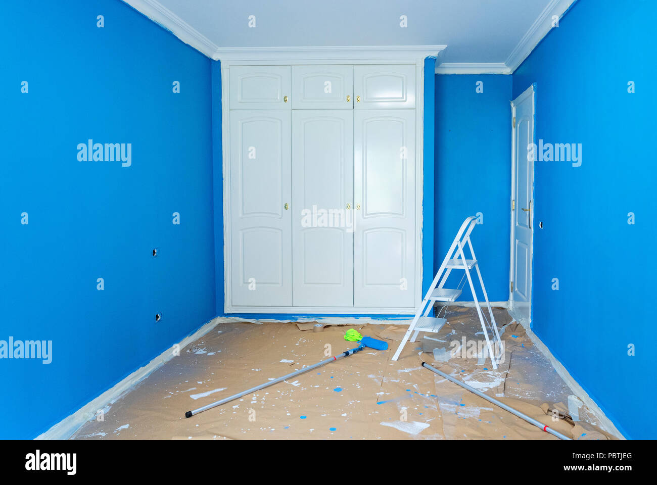 home renovation concept - old flat during restoration or refurbishment with newly painted blue walls Stock Photo