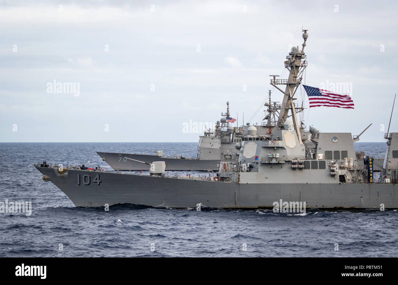 180726-N-LI768-1324 PACIFIC OCEAN (July 26, 2018) – Guided-missile destroyer USS Sterett (DDG 104) and guided-missile cruiser USS Lake Erie (CG 70) transit the Pacific Ocean while underway during the Rim of the Pacific (RIMPAC) exercise, July 26. Twenty-five nations, 46 ships, five submarines, and about 200 aircraft and 25,000 personnel are participating in RIMPAC from June 27 to Aug. 2 in and around the Hawaiian Islands and Southern California. The world's largest international maritime exercise, RIMPAC provides a unique training opportunity while fostering and sustaining cooperative relation Stock Photo