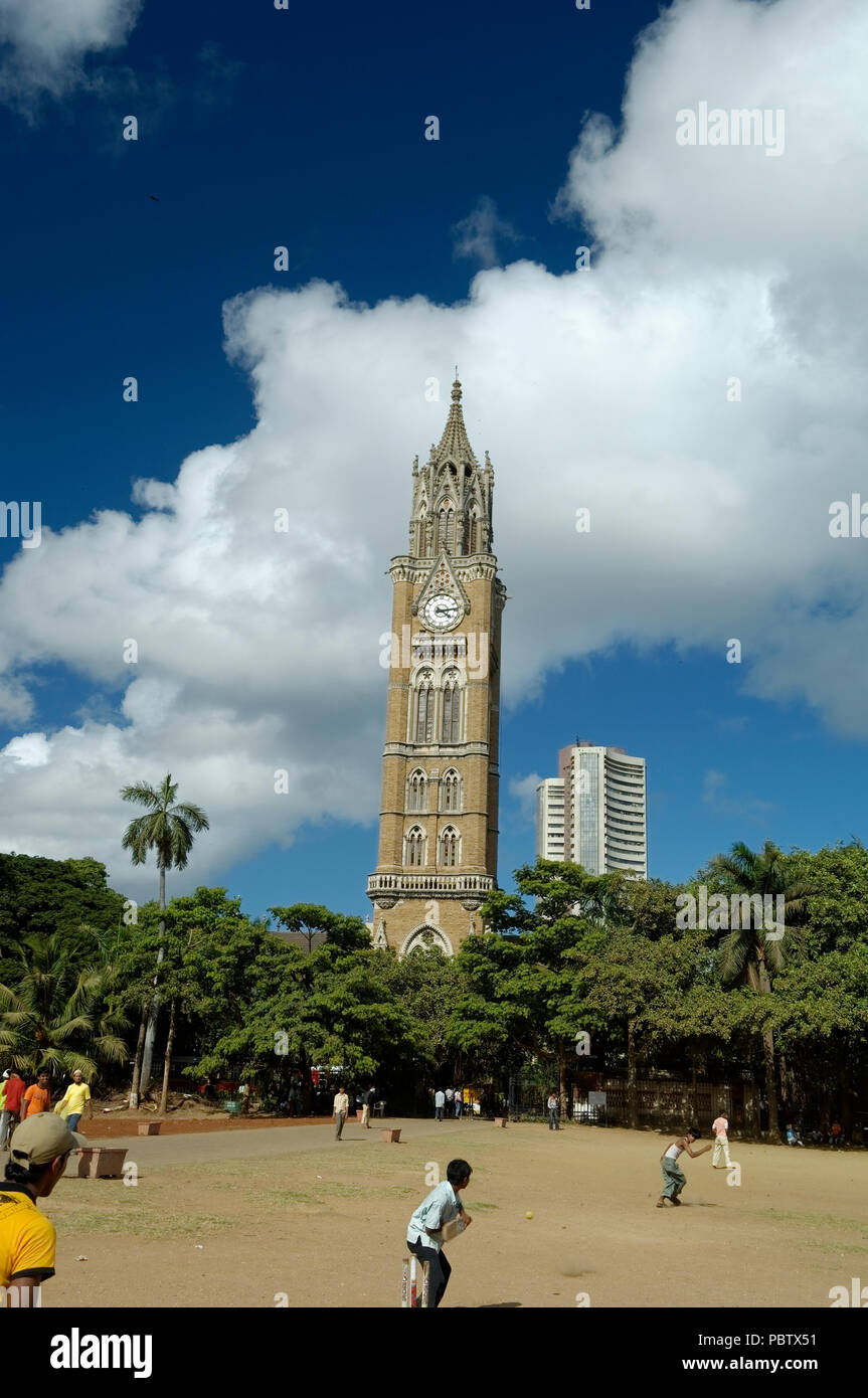Boys playing Cricket in the background of Rajabai Tower historic clock
