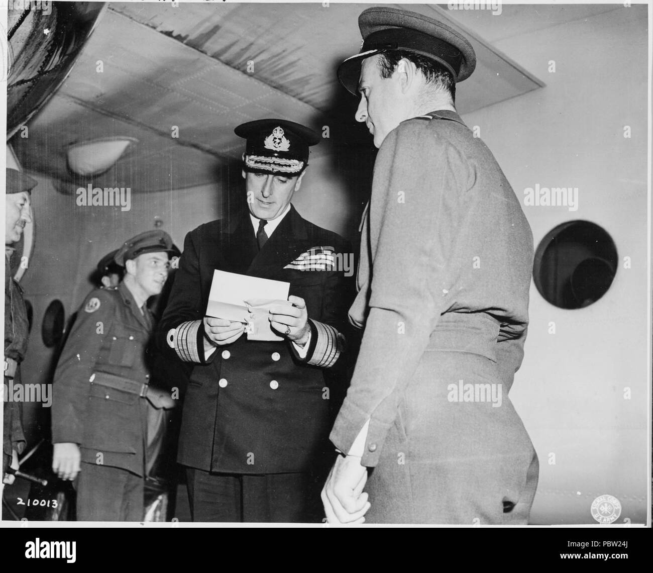 Adm. Lord Louis Mountbatten, cousin of the King of England and Commander of the Southeast Asia Command, reads a... - Stock Photo