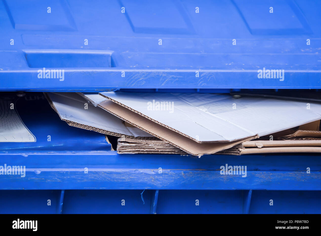 A blue bin for old paper and cardboard boxes Stock Photo Alamy