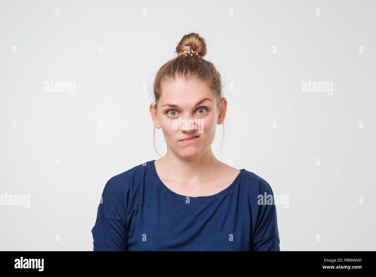 Young discontent europeam woman is discontent and is frowning her face with disgust. Stock Photo