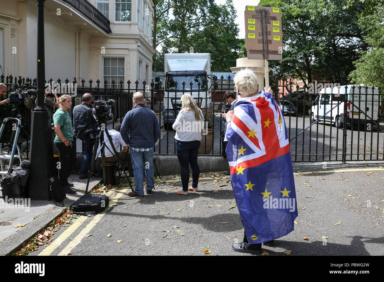 Carlton Gardens, Westminster, London, UK, 30th July 2018. Faux Bojo (Drew  Galdron, a Boris impersonator) turns up on moving day to entice Boris out  of the residence. Removal vans are seen loading