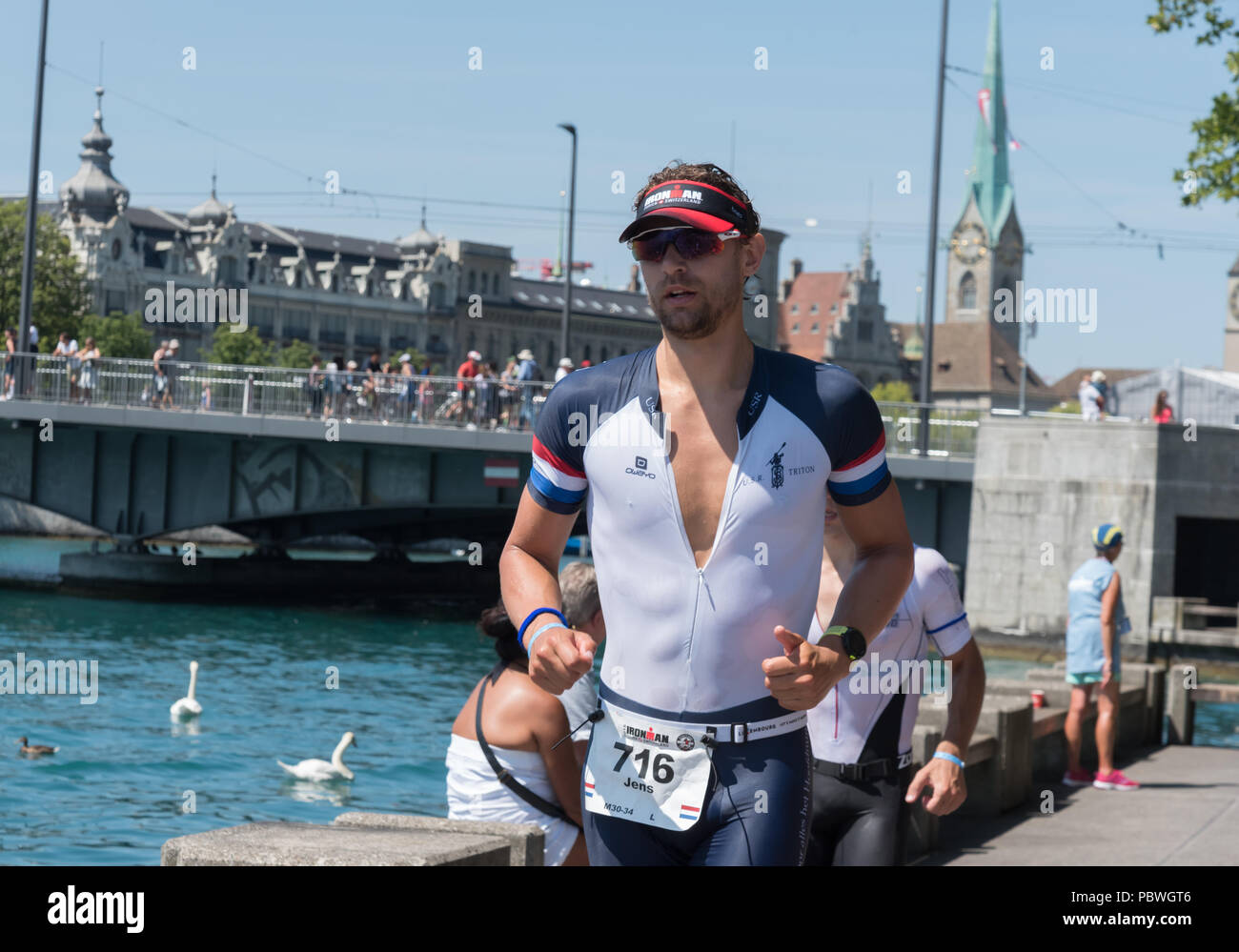 The Switzerland, 2018, Ironman Triathlon: Running  course. A contestant running through the city of Zurich, Bellevue. Stock Photo