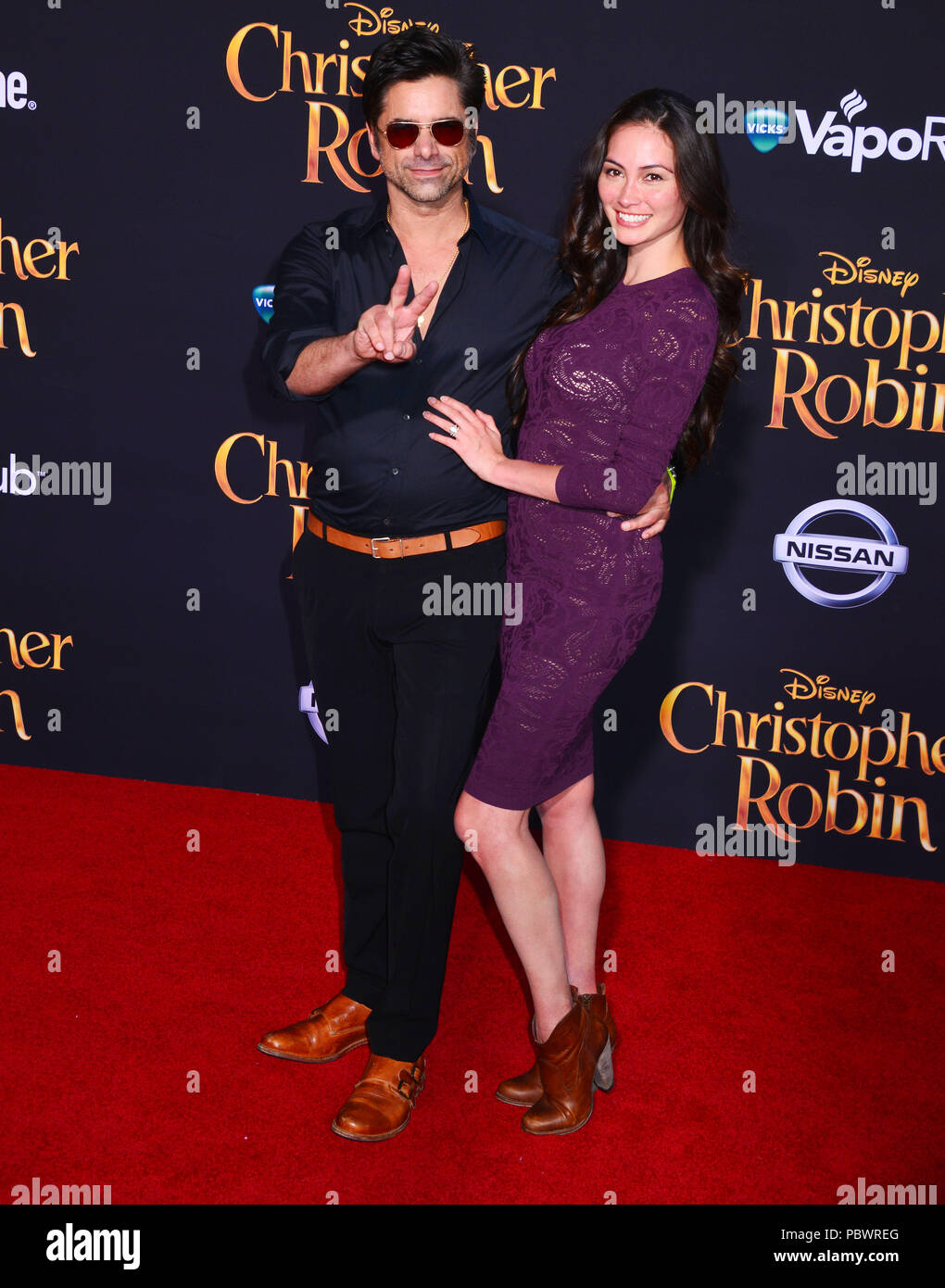 Burbank, California, USA. 30th July 2018. John Stamos, Caitlin McHugh 056 attends the premiere of Disney's 'Christopher Robin' at Walt Disney Studios on July 30, 2018 in Burbank, California. Credit: Tsuni / USA/Alamy Live News Stock Photo