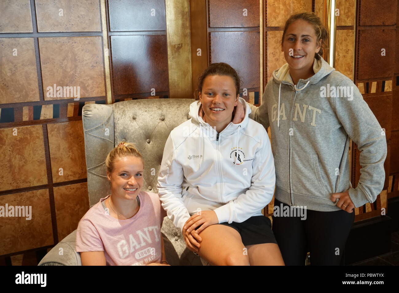 30.07.2018, Great Britain, London: Hockey, World Cup, Field, Ladies. The hockey players (l-r) goalkeeper Julia Ciupka, Charlotte Stapenhorst, Marie Maevers from Germany sit in the London team hotel Grange City. The German women's hockey team will once again face Spain in the quarter-finals of the World Cup in London. The Olympic bronze medallist Germany had previously secured first place in preliminary round group C with three wins and was thus directly qualified for the round of the best eight. Photo: Nina Niedermeyer/dpa Stock Photo