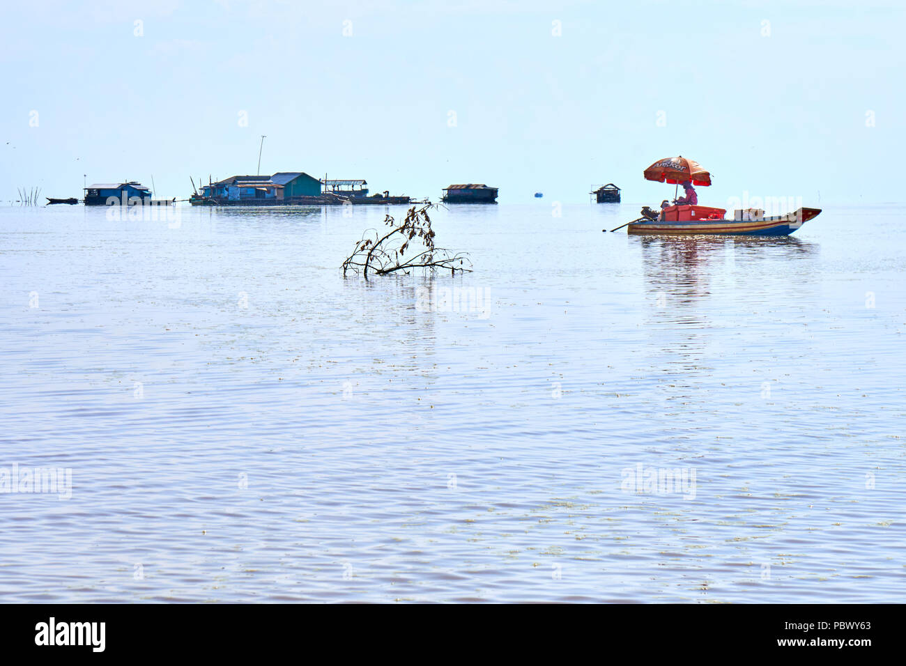 Fishing boat reflected on Tonle Sap lake in Cambodia Stock Photo