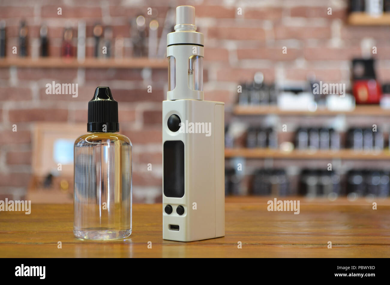 Electronic cigarette with ejuice bottle on a background of vape shop. E-cigarette for vaping. Popular vape devices Stock Photo