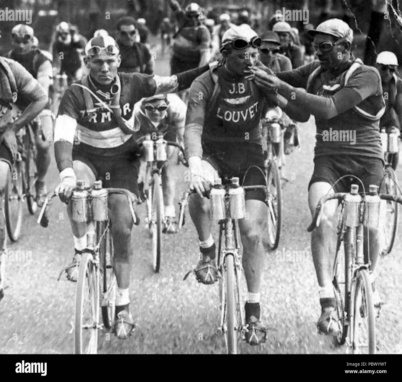 TOUR DE FRANCE 1927. Belgian riders Julien Vervaecke (at left) and Maurice Geldhof (centre) smoking during a stage of the Tour. Stock Photo