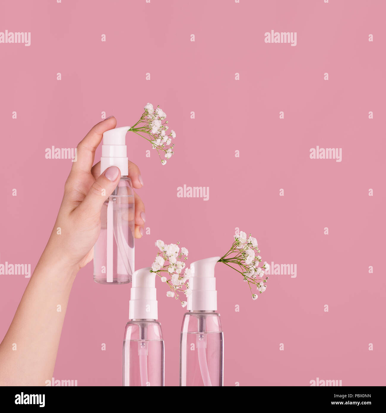 bottle of perfume with spray scent of flowers Stock Photo Alamy