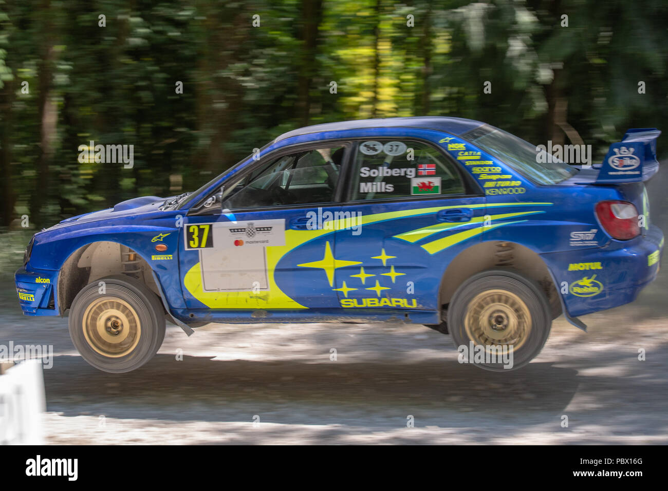 An air bourne Subaru Impreza rally car in the forest stages of the Goodwood Festival of Speed 2018 Stock Photo