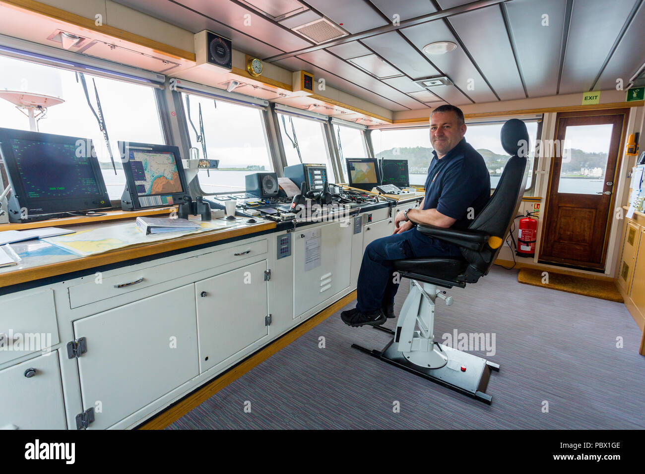 Captain Mike Smith of the NLB buoy tender 'Pole Star' on the bridge while berthed at the NLB depot in Oban, Argyll and Bute, Scotland, UK Stock Photo