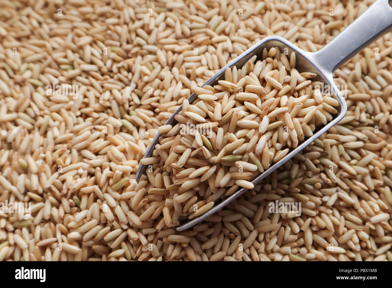 Raw brown rice in a spoon and bowl. top view food background Stock ...