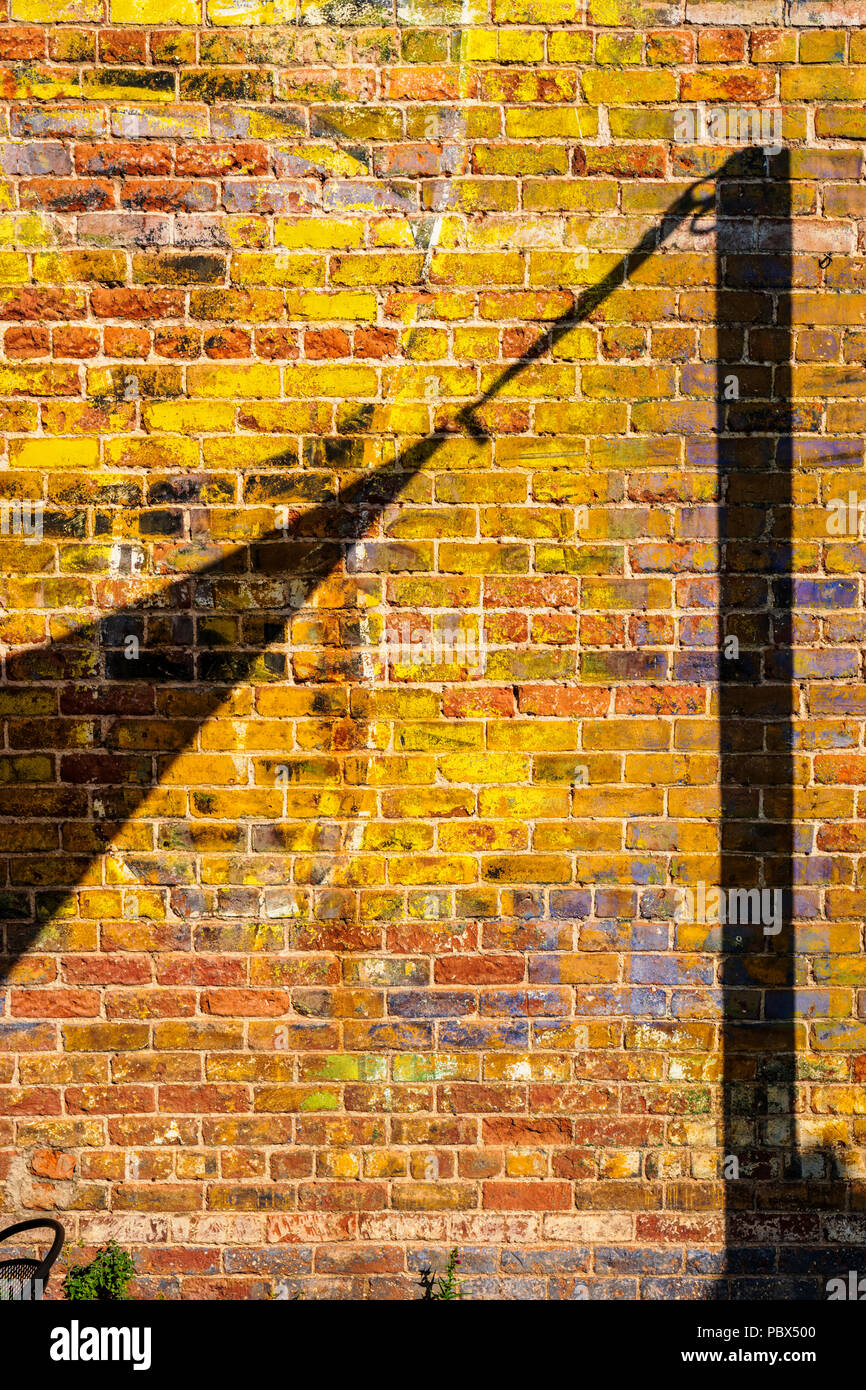 Old signage painted on the brick exterior of The Fritz; local cafe; bar & restaurant; Salida; Colorado; USA Stock Photo