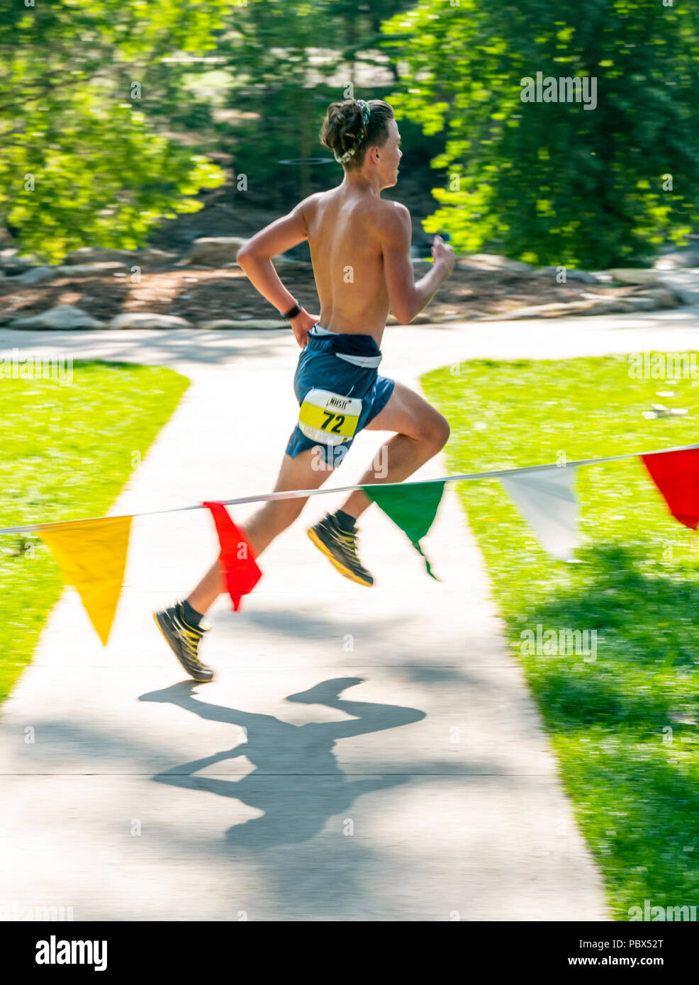Pan blur motion image of runner finishing National High School Trail Championship (NHSTC) ; Salida; Colorado; USA Stock Photo