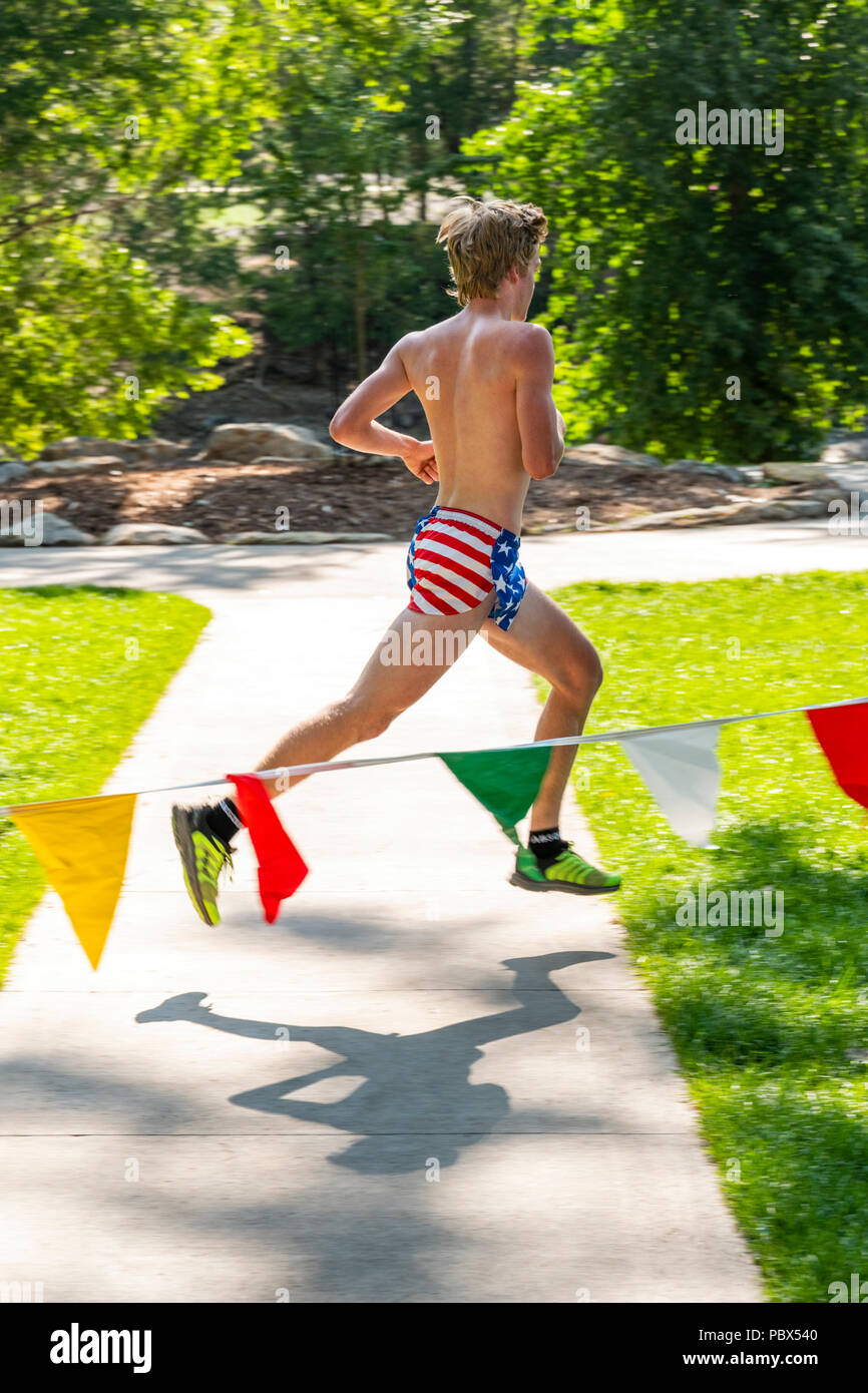Runner in American Flag shorts finishing National High School Trail Championship (NHSTC) ; Salida; Colorado; USA Stock Photo