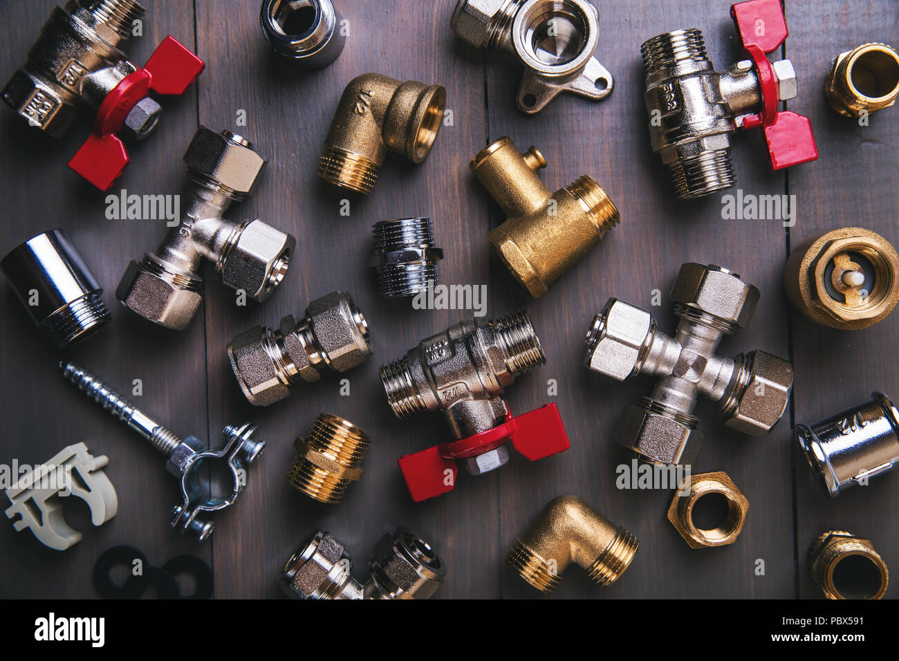 group of plumbing fittings and equipment on wooden background Stock Photo