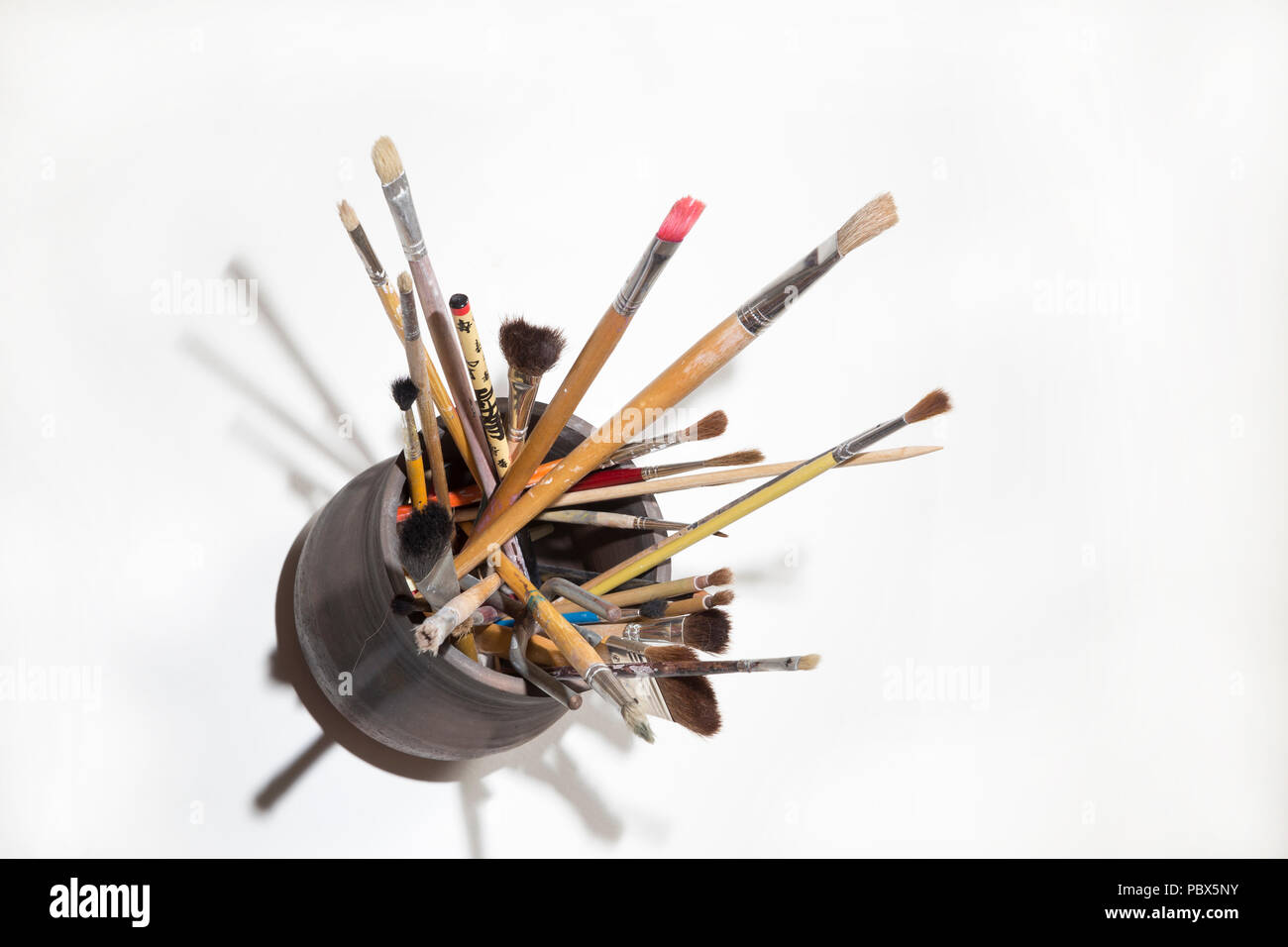 top view of a boat with a cluttered group of brushes of various shapes and sizes Stock Photo