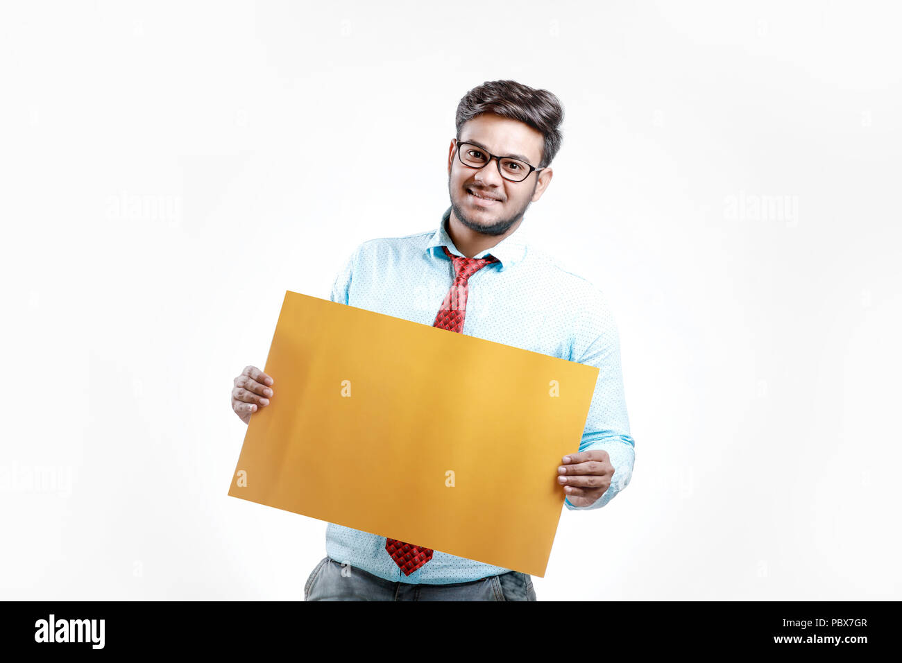 happy Young indian man showing blank poster Stock Photo