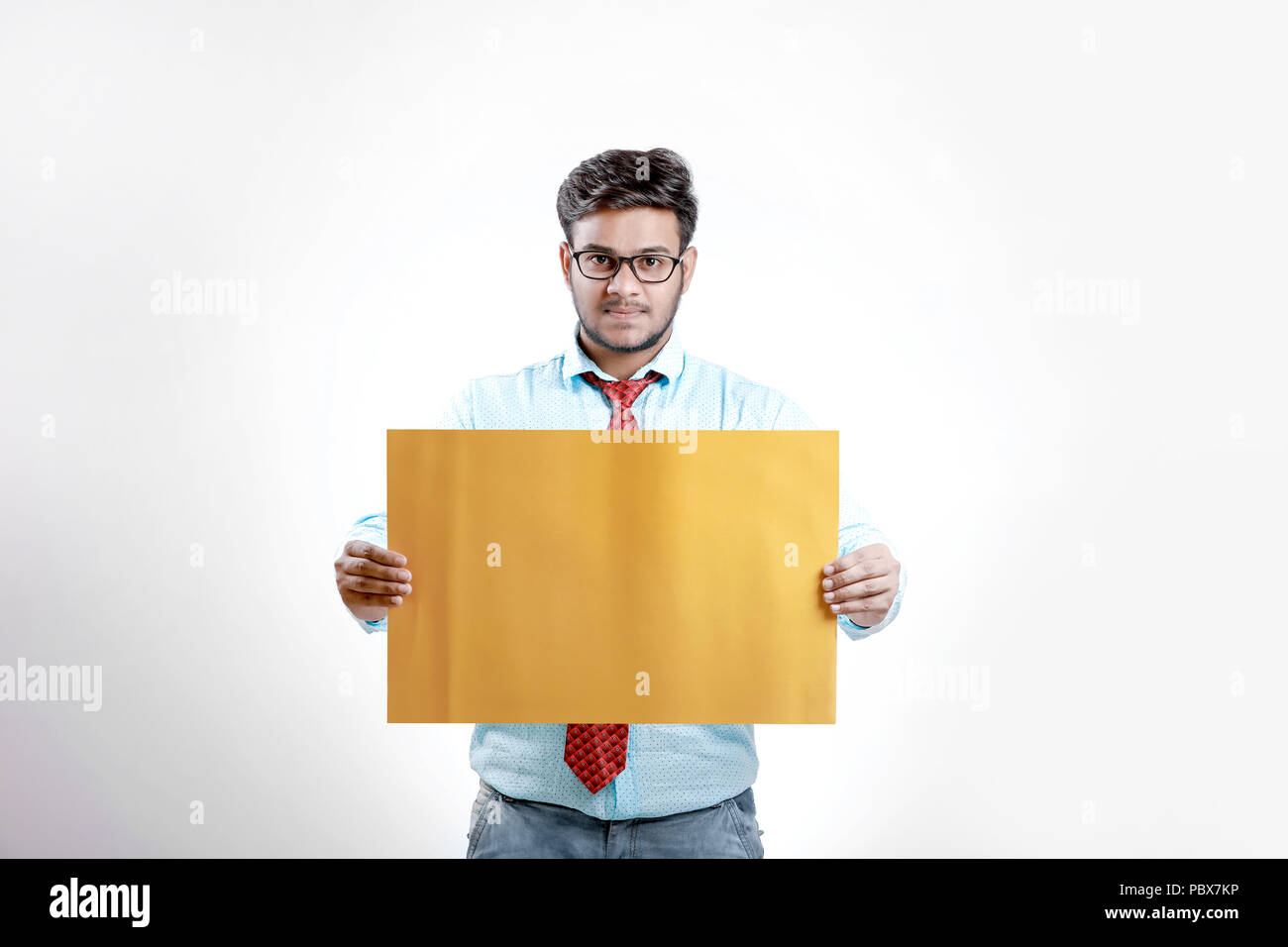 happy Young indian man showing blank poster Stock Photo