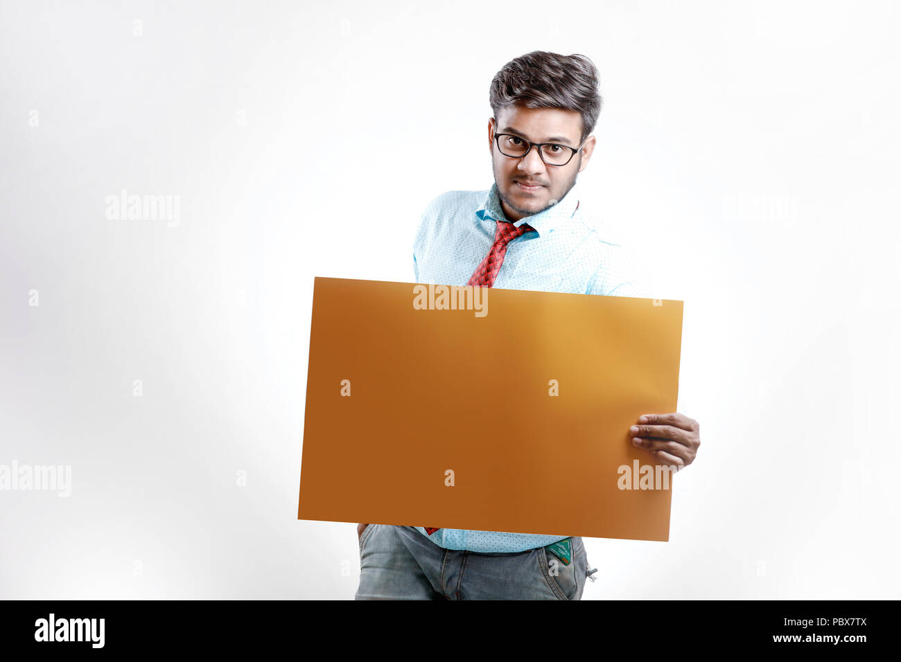 happy Young indian man showing blank poster Stock Photo