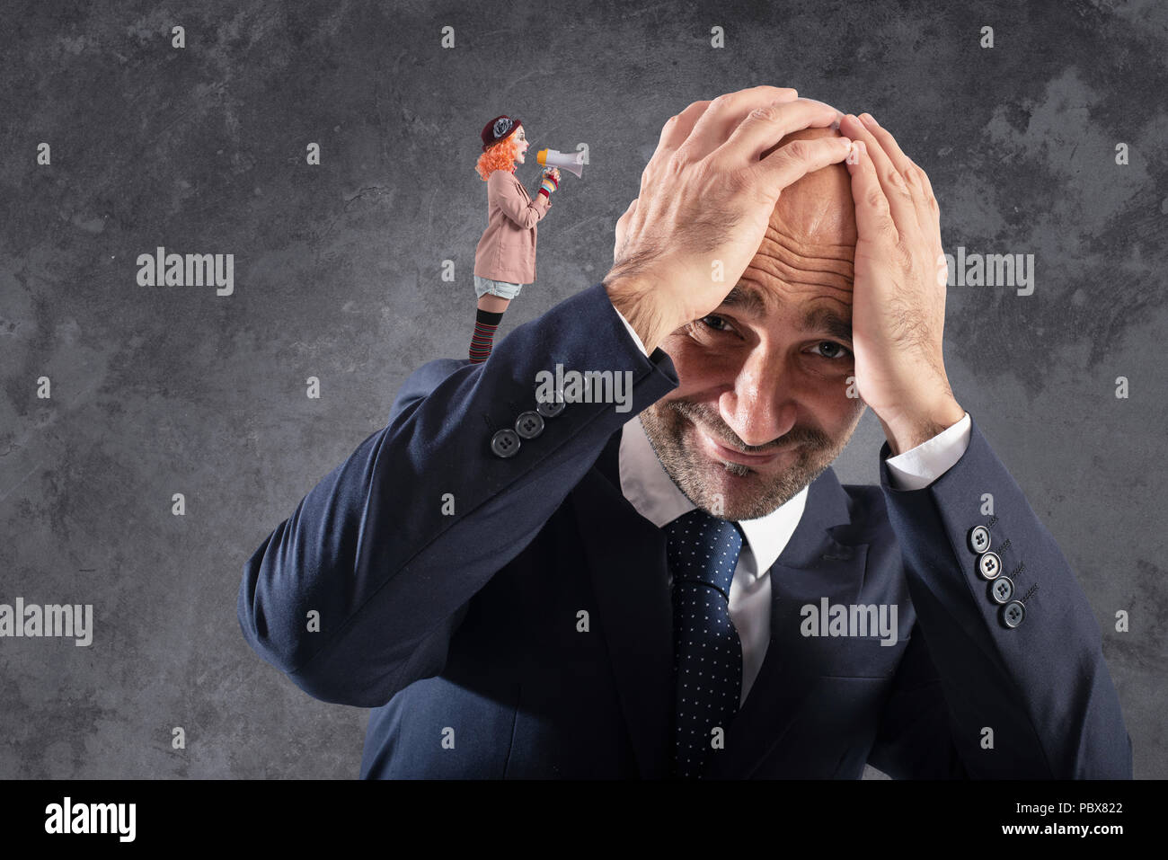 Clown that shuts with megaphone to a businessman Stock Photo