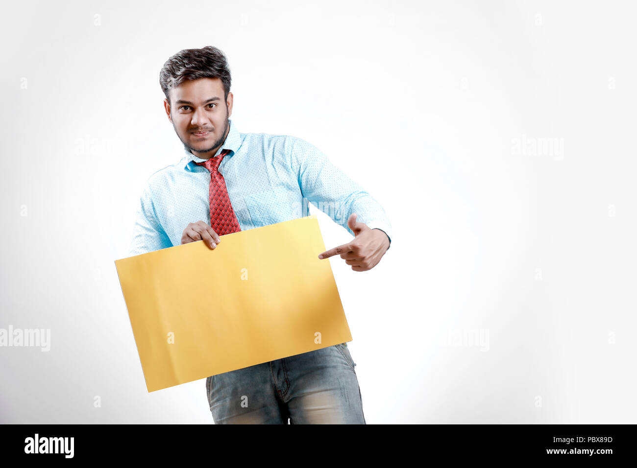 happy Young indian man showing blank poster Stock Photo