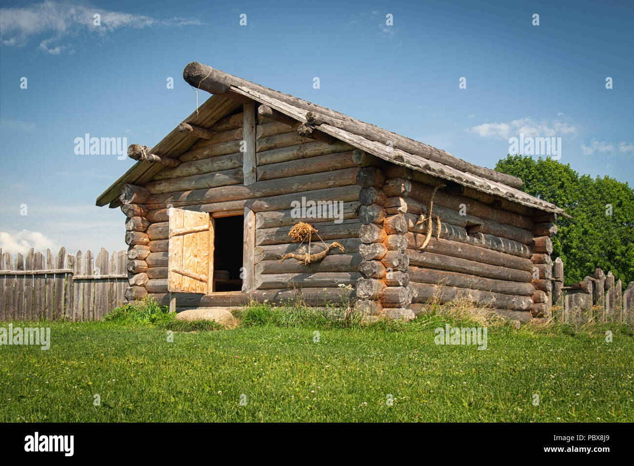 Ancient log house in a country side in a sunny day Stock Photo