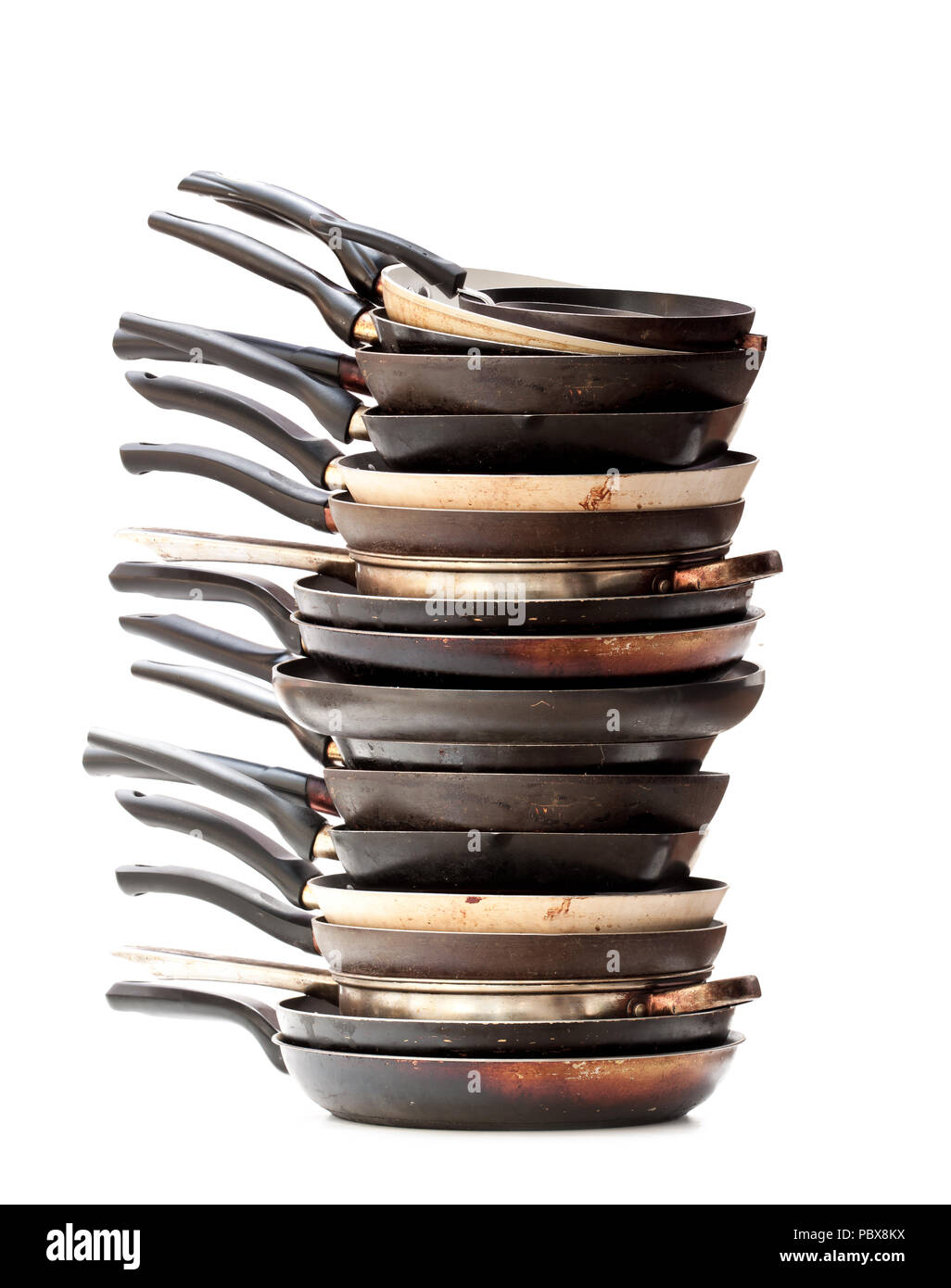 Stack of used frying pans isolated on white Stock Photo Alamy