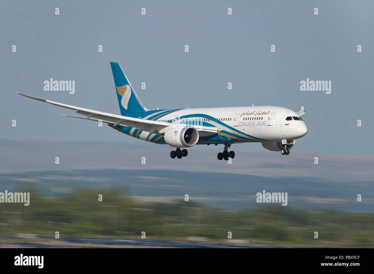 An Oman Air Boeing 787-8 comes in to land at Manchester Airport, UK. Stock Photo