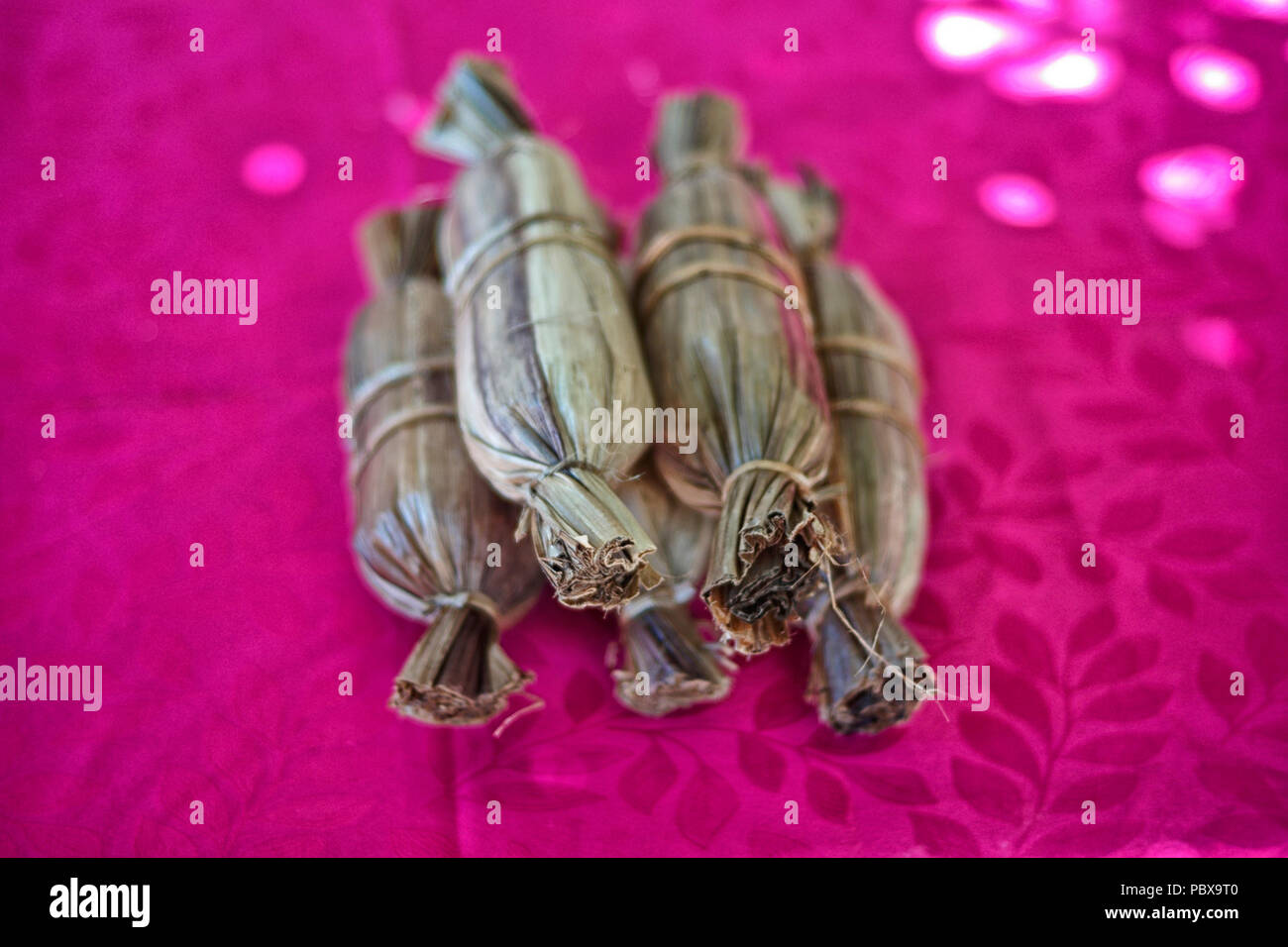 Alfandoques, traditional sweets made out of panela, wrapped in plantain leafs Stock Photo