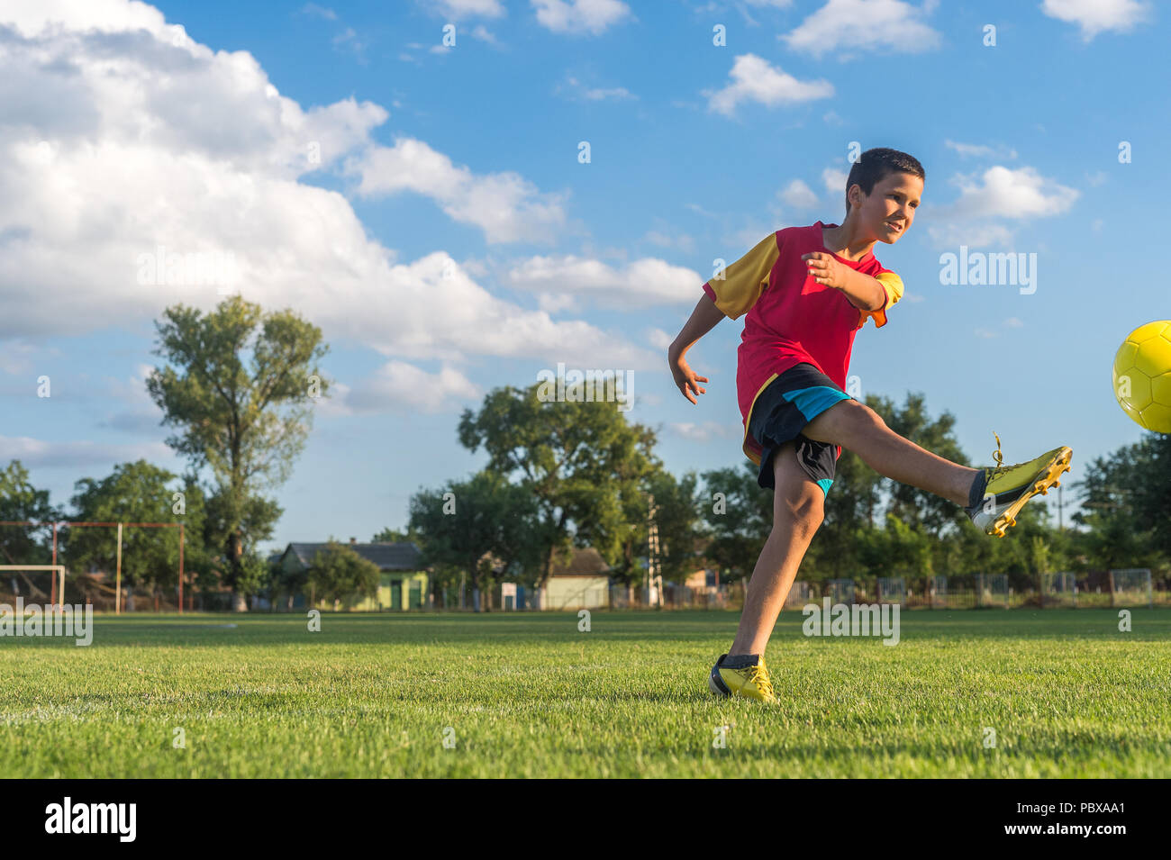 Little Boy Kicking ball at Goal Stock Photo Alamy