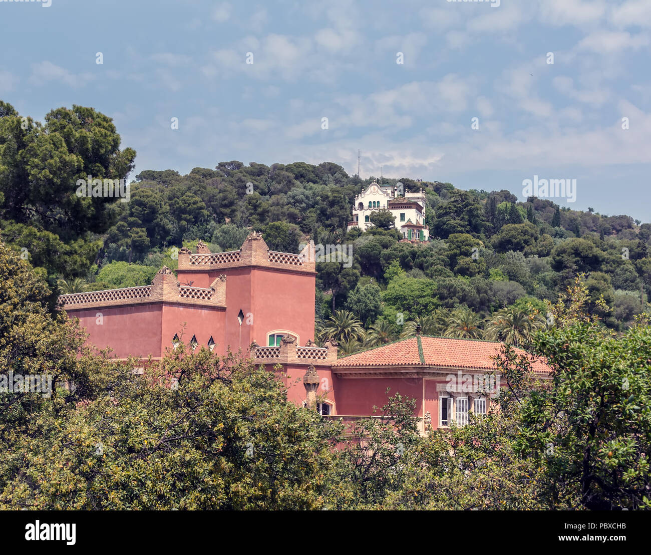 Red eighteenth century building of Baldiri Reixac school (former farmhouse residence of Count Guell), named Casa Larrard, and white Casa Trias Stock Photo