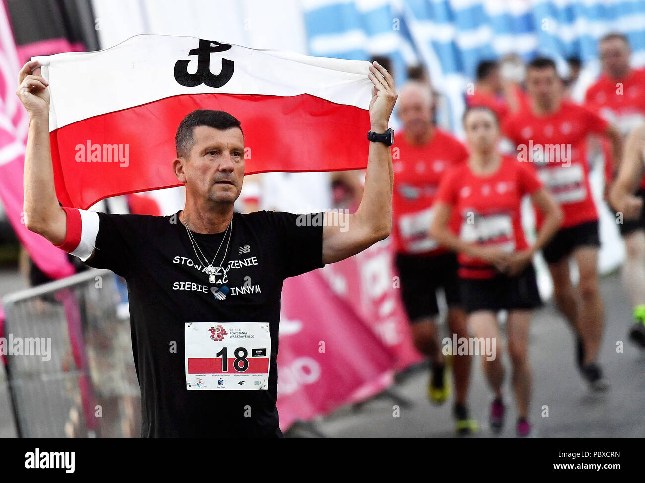 Thousands of people participate in 28th Warsaw Uprising Run on July 28, 2018 in Warsaw, Poland.  The runners commemotate those who fight and died in a Stock Photo