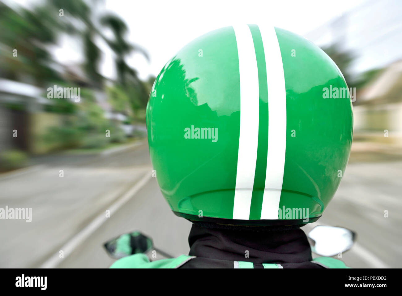 rear-view-of-motorcycle-taxi-ride-with-fast-on-the-urban-street-stock
