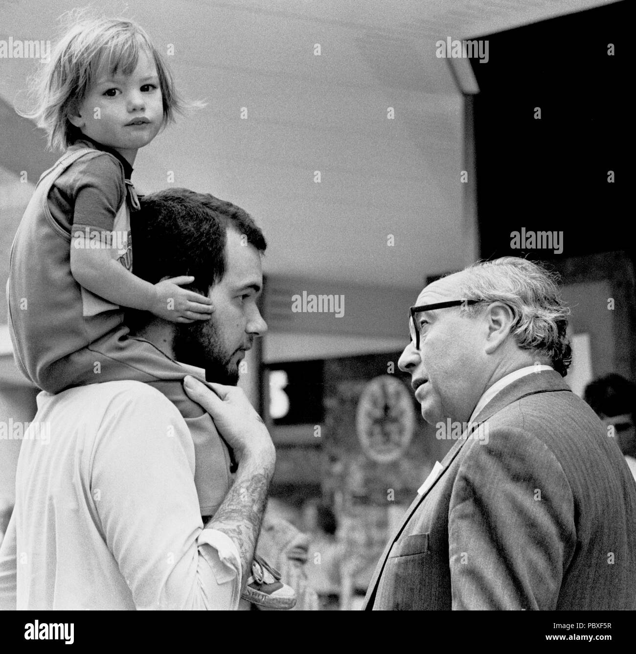 Cameras captivate three-year-old Willy Crompton at Warrington as his father Bill talks to former Labour Minister Roy Jenkins (r), who was canvassing for support in the forthcoming by-election in which he is to stand as SDP candidate. Stock Photo