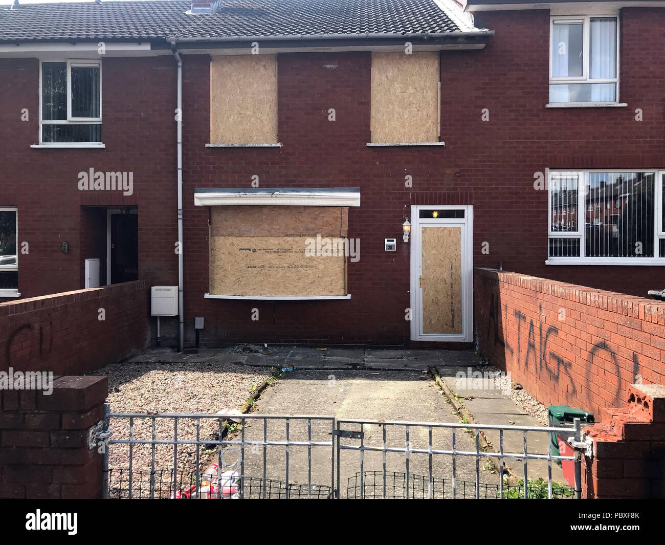The boarded up house of a grieving mother who was ordered from her Belfast home by loyalist paramilitaries as she waited to bring her son's body home. Stock Photo