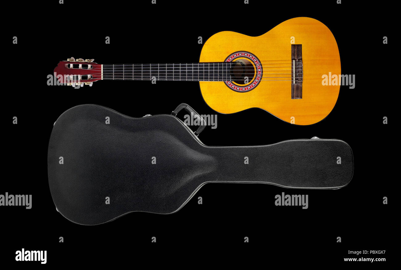 Musical instrument - Acoustic classic guitar hard case isolated on a black background. Stock Photo