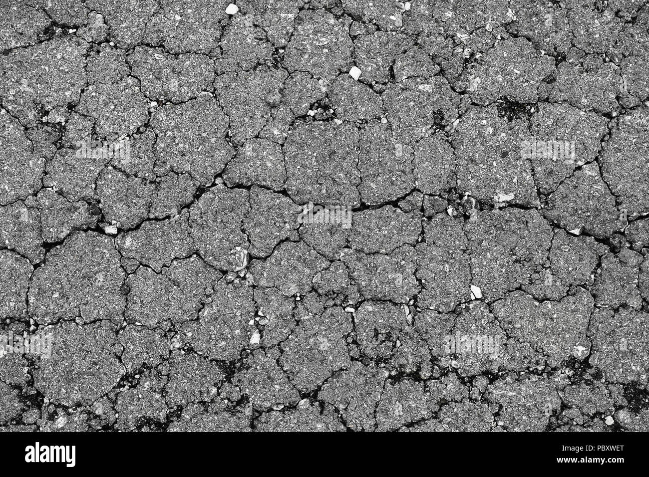 Crack asphalt pavement texture with small rocks High Resolution Background for highway backdrop design Stock Photo