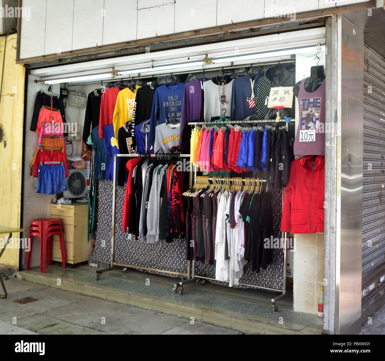 A stand selling clothes in an alley, Sham Shui Po, Kowloon, Hong Kong. Stock Photo