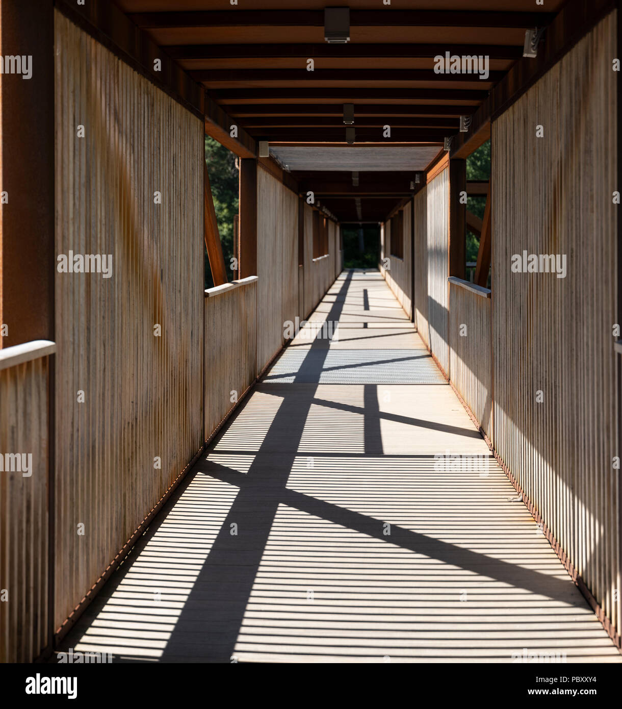 A covered wooden pedestrian and cyclist bridge in Norway Stock Photo